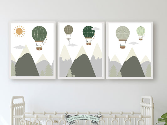 Create a serene and cozy nursery with our Hot Air Balloon Nursery Prints, featuring charming balloons soaring above mountains and forests in soothing green, grey and brown tones.