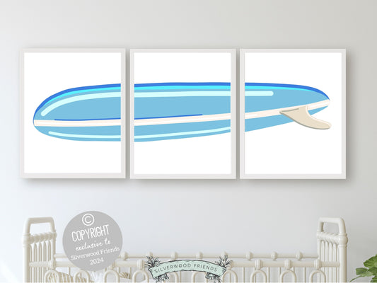  Set of 3 blue Surfboard Prints, featuring a minimalist design perfect for a baby's beach house nursery or boys surfing room. 