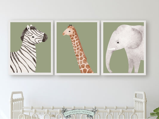 Safari Animal Nursery Prints Set of 3 featuring adorable watercolour safari animals on a green background. These delightful prints are perfect for your safari nursery decor and also make a lovely gender neutral safari baby shower gift.