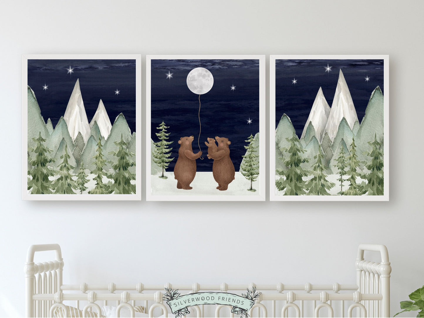 Set of 3 Bear Nursery Prints featuring a family of bears holding the moon under a starry night sky surrounded by a serene watercolour mountain and woodland forest landscape. Its ideal for your woodland nursery and makes a unique baby shower gift.