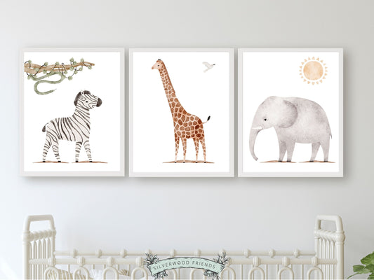 Safari Animal Nursery Prints Set of 3 featuring watercolour zebra, giraffe and elephant. These delightful prints are perfect for your safari nursery decor and also make a lovely gender neutral safari baby shower gift.