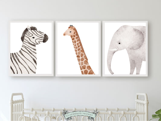 Safari Animal Nursery Prints Set of 3 featuring adorable watercolour zebra, giraffe and elephant. These delightful prints are perfect for your safari nursery decor and also make a lovely gender neutral safari baby shower gift.