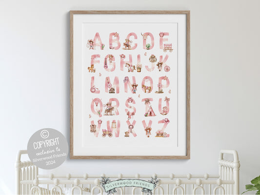 Cowgirl Alphabet Nursery Print, showcasing watercolor cowgirl essentials in soft pink and brown hues. These charming artworks blend rustic appeal into your cowgirl decor, ideal for your little ones space or as a baby shower gift.