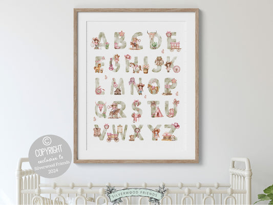 Cowgirl Alphabet Nursery Print showcasing watercolor cowgirl essentials in soft pink, brown and green hues. This charming artwork blends rustic appeal into your cowgirl themed decor, ideal for your little ones space or as a baby shower gift.