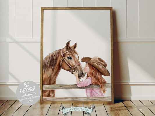 Digital print depicting a red haired cowgirl kissing her beloved horse atop a paddock fence. This artwork enhances your cowgirl themed decor, perfect for your little ones space or as a heartfelt baby shower gift for horse riding enthusiasts.