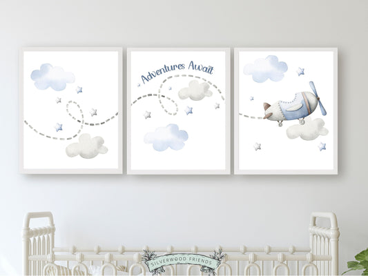 Nursery wall art set of 3 digital prints featuring blue watercolor airplane with clouds, stars and quote adventures await. Perfect for your air balloon nursery, adventure theme nursery or transport nursery decor. Digital prints.