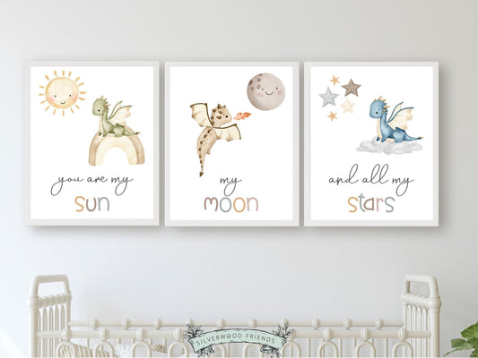 Transform your baby's nursery into a harmonious and dreamy sanctuary with this You Are My Sun Dragon Nursery Prints featuring baby dragons, a sun, moon, stars, and the loving quote "You are my sun, my moon, and all my stars." Perfect for your dragon nursery decor and as a baby shower gift.