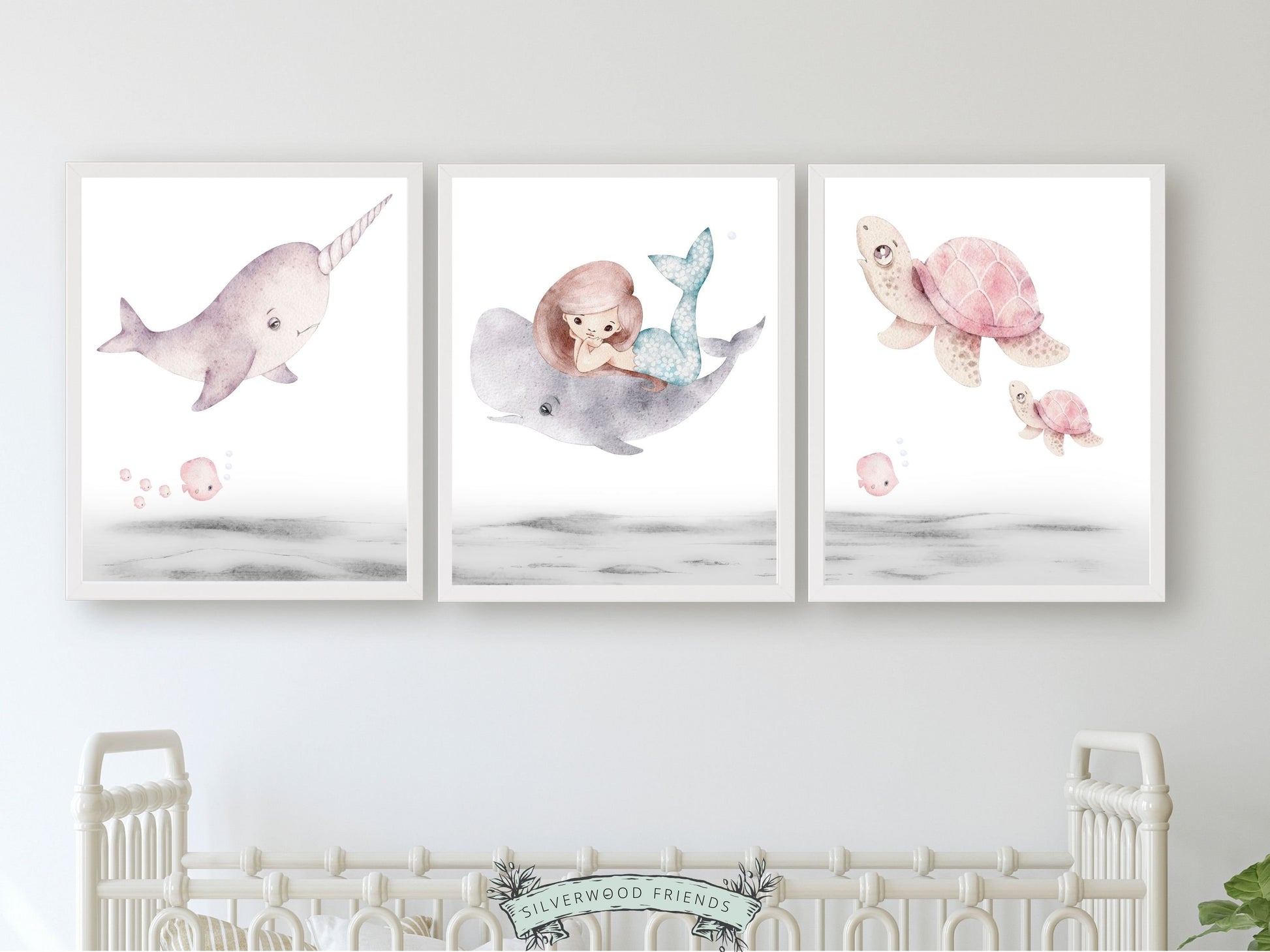 Create an enchanting underwater nursery oasis with our pastel Mermaid Nursery Prints Set of 3, featuring beautiful watercolour illustrations of a mermaid and whale swimming alongside a narwhal and sea turtles to add a touch of magic to your baby girl's nursery decor.