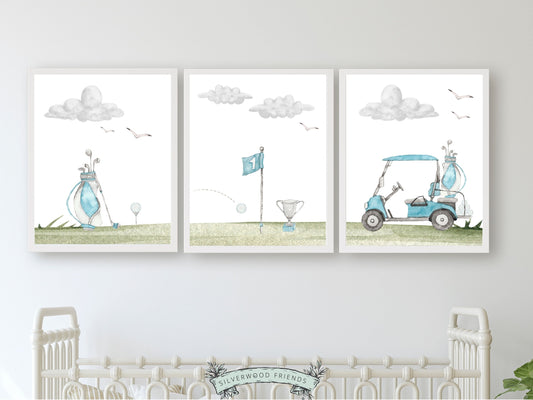 Elevate your baby boy's nursery decor with this Set of 3 Blue Golf Nursery Prints, featuring watercolour illustrations of golf balls, carts, and golf bags, providing the perfect decorative touch for your sports-inspired nursery decor or golf-themed baby shower.