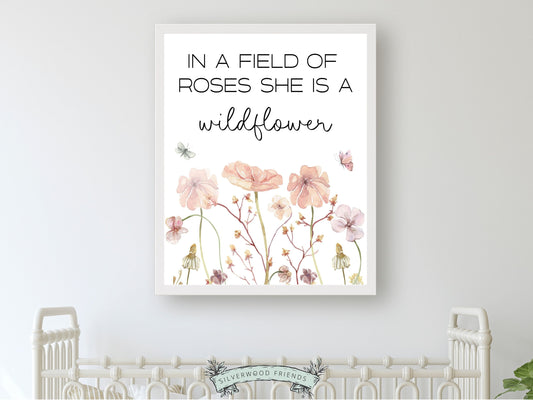 Our gorgeous wildflower nursery print with watercolor wildflower meadow flowers and quote In a field of roses she is a wildflower, is perfect for your wildflower nursery decor and part of our best selling wildflower collection.