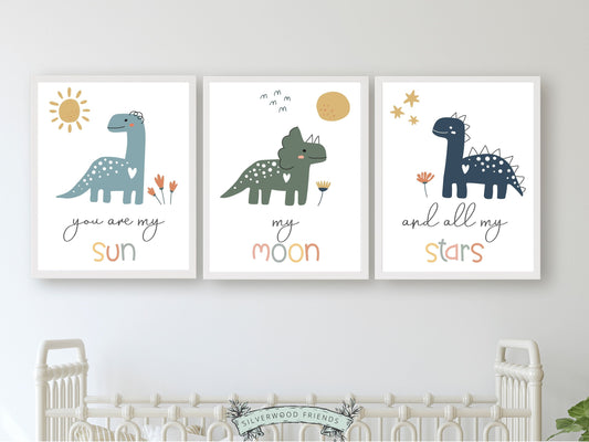 This Set of 3 Dinosaur Nursery Prints, featuring a sun, moon, stars and dinosaurs, along with the loving and positive quote "You are my sun, my moon, and all my stars" will create a dreamy atmosphere in your little one's nursery and also makes the perfect dinosaur baby shower gift.