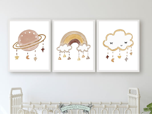 Set of 3 Boho Baby Nursery Prints. Delicately crafted watercolour planets, rainbows, and clouds adorned with whimsical stars will infuse a harmonious and dreamy ambiance, making it an enchanting gender neutral baby shower gift.