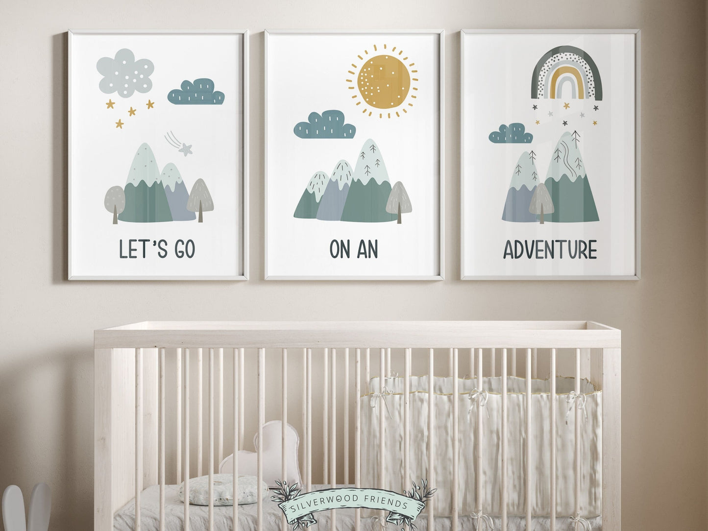 Our Set of 3 Boho Mountain Nursery Prints, featuring Nordic mountains, a sun, clouds, stars, rainbow, and the quote, Lets go on an adventure, in tranquil blue and green tones will create a dreamy atmosphere in your little one&#39;s nursery.