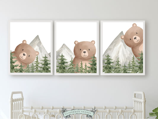 Our delightful Set of 3 Peeking Bear Woodland Nursery Prints features adorable peeking brown bears with watercolour woodland forest trees and mountain landscape. Its perfect for your bear nursery decor or woodland nursery and makes a unique baby shower gift.