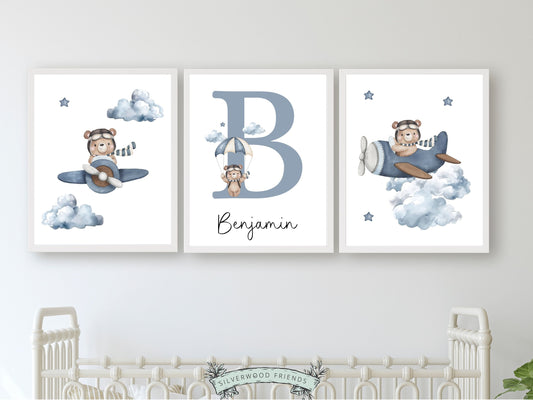 Teddy Bear Custom Name Nursery Prints, showcasing adorable watercolour teddy bears soaring through the sky on airplanes and parachutes amidst a dreamy cloud and star studded sky. The perfect addition to your bear themed nursery or transport inspired bedroom, these prints also make a unique baby shower gift.