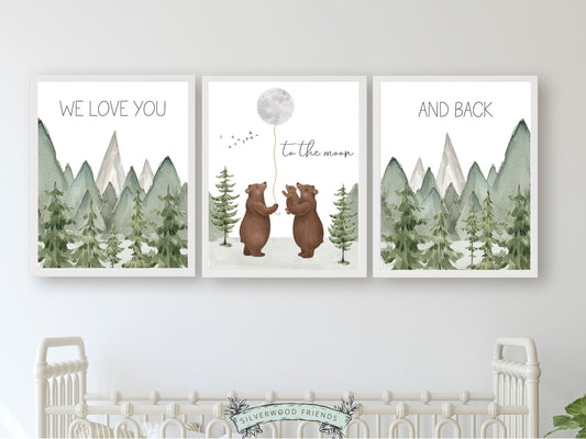 Set of 3 Bear Nursery Prints featuring a family of bears holding the moon and quote We love you to the moon and back and set against a watercolour mountain and woodland forest landscape. Ideal for your woodland nursery and makes a unique baby shower gift.