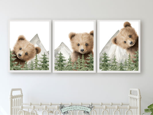 Set of 3 Peeking Bear Woodland Nursery Prints features adorable peeking brown bears with watercolour woodland forest trees and mountain landscape. Its perfect for your bear nursery decor or woodland nursery decor and makes a unique baby shower gift.